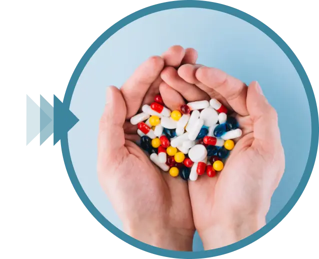 Hands holding a pile of colorful pills